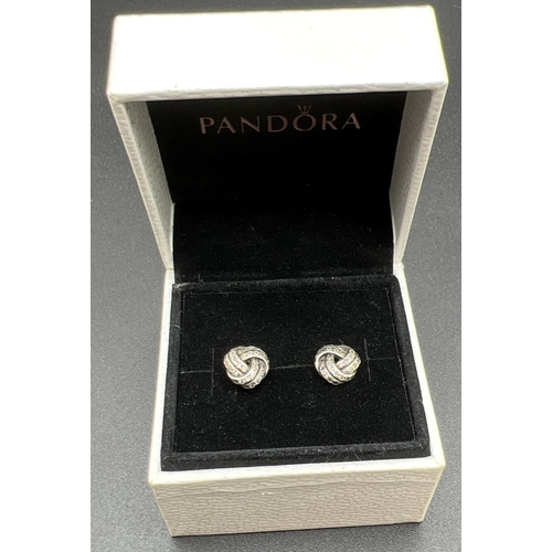 1108 - A boxed pair of silver Sparkling Love Knot stud style earrings by Pandora, set with small round cut ... 