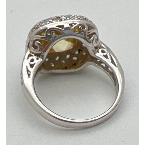 1112 - A silver, lemon quartz and cubic zirconia cocktail ring with central cushion cut stone. Surrounded b... 