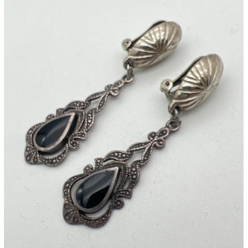 1115 - A pair of silver drop style clip on earrings. Each set with a teardrop of black onyx in a Gothic sty... 