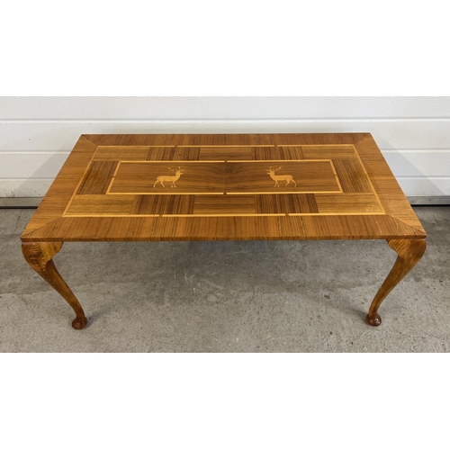 1453 - A vintage light wood coffee table, marquetry design to top with stag detail. Raised on cabriole styl... 