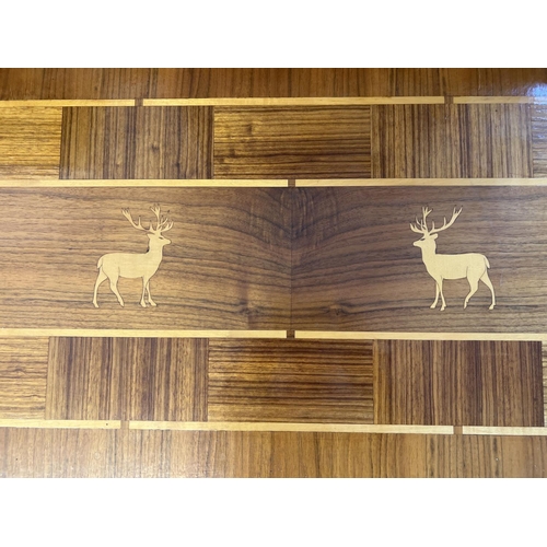 1453 - A vintage light wood coffee table, marquetry design to top with stag detail. Raised on cabriole styl... 