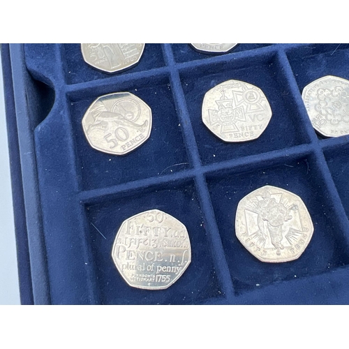 36 - A collection of 14 collectors 50p coins together with a Westminster coin collectors case with 2 lift... 