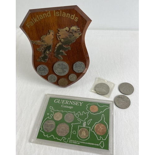 45 - A cased Guernsey Coinage set together with a wooden plaque with Falklands Liberation coins and 3 com... 