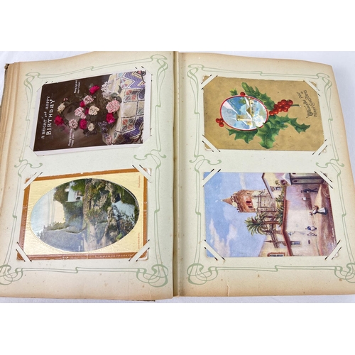 242 - An Art Nouveau postcard album containing 160+ assorted British & overseas postcards and greetings ca... 