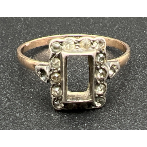 1078 - A vintage 9ct gold and silver dress ring. Square set mount with central stone missing, with 14 small... 