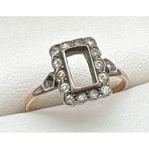 1078 - A vintage 9ct gold and silver dress ring. Square set mount with central stone missing, with 14 small... 