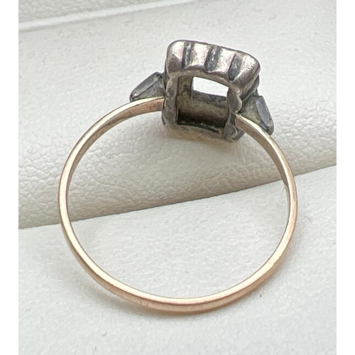 1078 - A vintage 9ct gold and silver dress ring. Square set mount with central stone missing, with 14 small... 