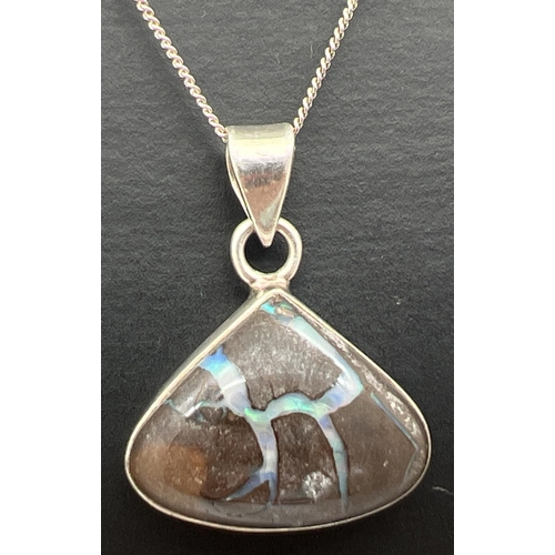 1016 - A modern design silver triangular pendant set with a boulder opal, on a 20