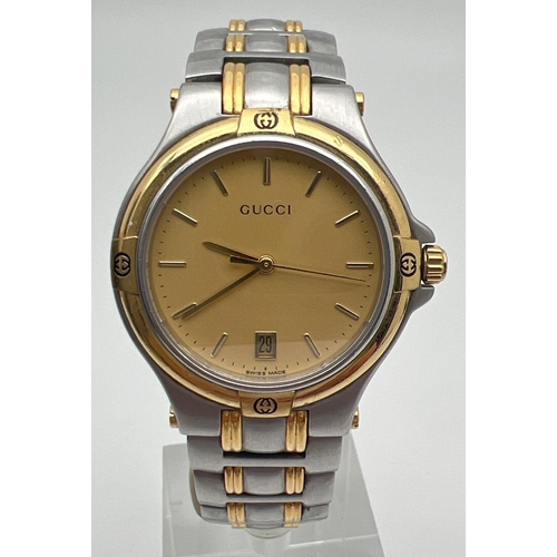 1155 - A men's 9040M wristwatch by Gucci. Gold and silver tone stainless steel strap and case. Gold tone fa... 