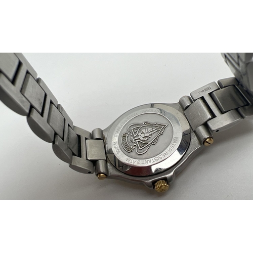 1155 - A men's 9040M wristwatch by Gucci. Gold and silver tone stainless steel strap and case. Gold tone fa... 