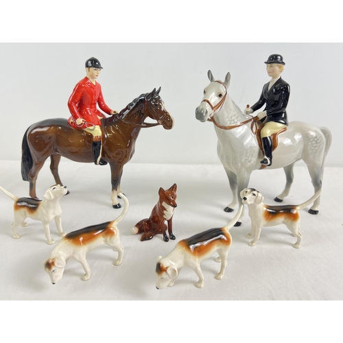 Beswick Huntsman, Huntswoman, fox and hounds ceramic figurines. #1501 Huntsman (style 2) in brown gloss finish (1957-95) with Beswick Crest backstamp; #1730 Huntswoman (style 2) in grey gloss finish (1960-95) with Beswick Crest backstamp; #1748 fox sitting in glass finish (1961-97) with oval backstamp; and 4 fox hounds - No.s 2262, 2263, 2264 & 2265 (2nd versions, 1969-97) - in gloss finish with oval backstamps.