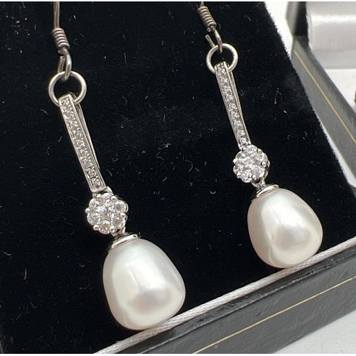 1037 - A 925 silver key shaped pendant set with 13mm pearl, on a 17