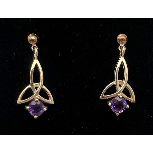 1043 - A pair of unmarked 9ct gold and amethyst drop earrings of Celtic design, complete with butterfly bac... 