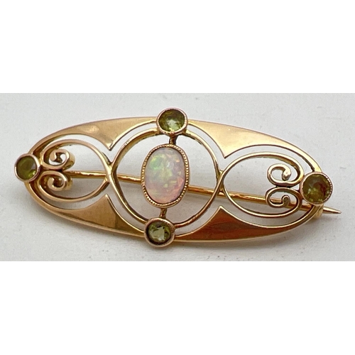 1044 - A Murrle Bennet & Co Art Nouveau 15ct gold brooch set with central oval cut opal and 4 small round c... 