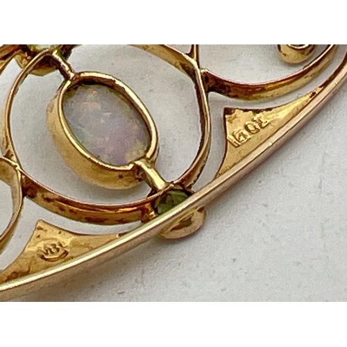 1044 - A Murrle Bennet & Co Art Nouveau 15ct gold brooch set with central oval cut opal and 4 small round c... 