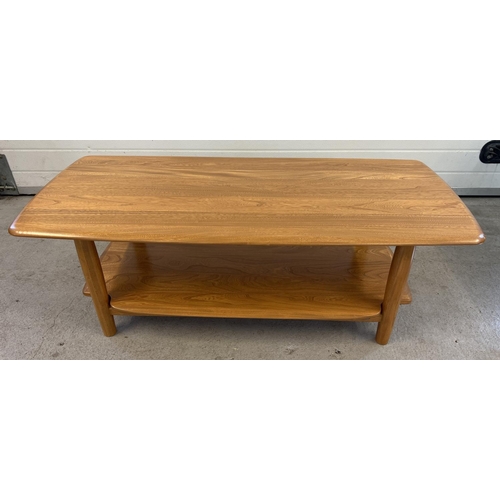 1419 - A modern Ercol light wood coffee table with rounded edges, undershelf and cylindrical legs. Approx. ... 