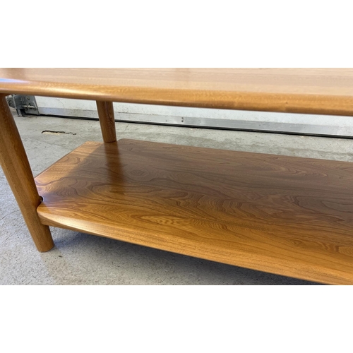 1419 - A modern Ercol light wood coffee table with rounded edges, undershelf and cylindrical legs. Approx. ... 