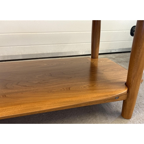 1419 - A modern Ercol light wood coffee table with rounded edges, undershelf and cylindrical legs. Approx. ... 