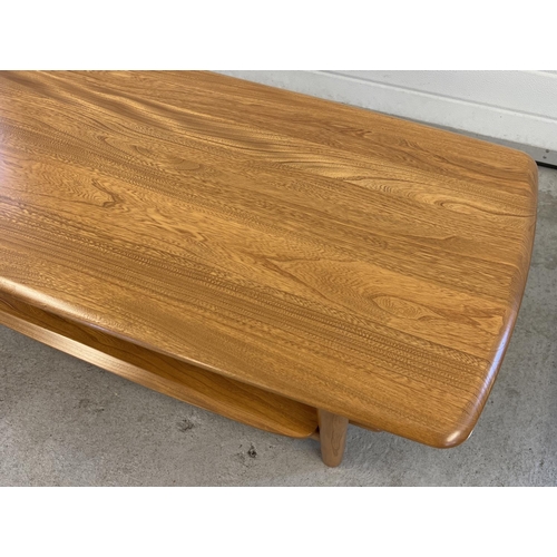 1419 - A modern Ercol light wood coffee table with rounded edges, undershelf and cylindrical legs. Approx. ... 