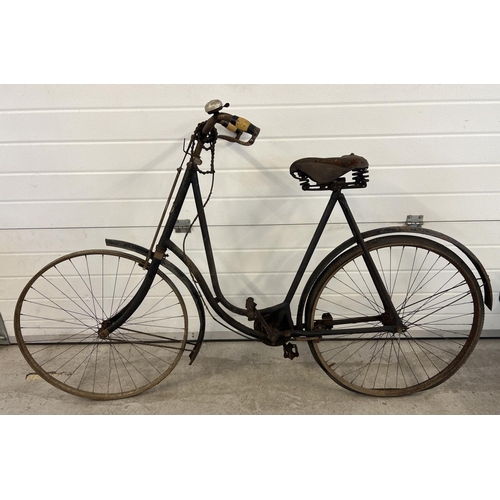 An early 20th century Imperial Rover of Coventry bicycle with leather Middlemore sprung saddle seat. In original condition - for refurbishment. Front tyre missing, chain present but not fitted. Some rusting throughout.