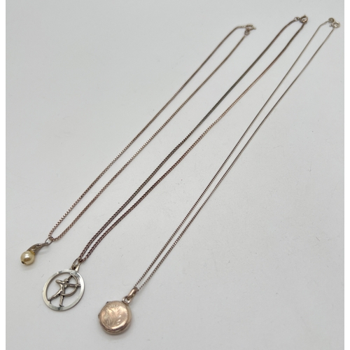 1055 - 3 silver & white metal pendant necklaces. A 925 silver small circular locket on an 18