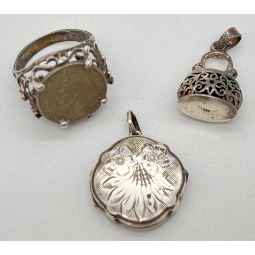 1056 - 3 vintage silver items. A locket with engraved foliate design to front, stamped silver to reverse; a... 
