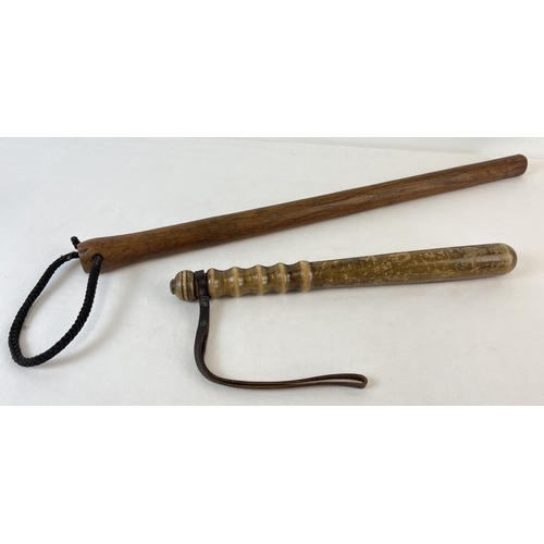 1323 - 2 vintage wooden truncheons. A traditional police style truncheon with ribbed handle and leather str... 