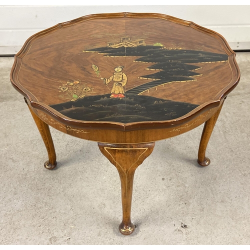 A vintage Northampton Cabinet company circular shaped coffee table with Chinoiserie decoration. 4 legged table raised on cabriole style legs with studded feet and hand painted gilt detail. Table top has scalloped rim and Chinese decoration in raised lacquer with figural scene in black, gold, red and green. Ivorine manufacturers label affixed to underside with 'Bonds Norwich' chalked. Table approx. 44cm tall x 61 cm diameter.