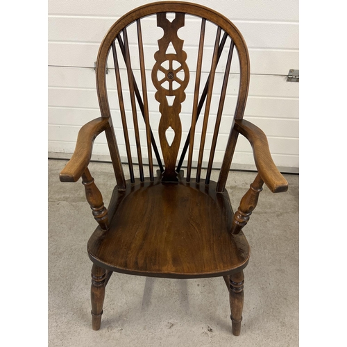 1425 - A vintage wheel backed elm wood Windsor armchair with spindled back and turned legs and arm supports... 