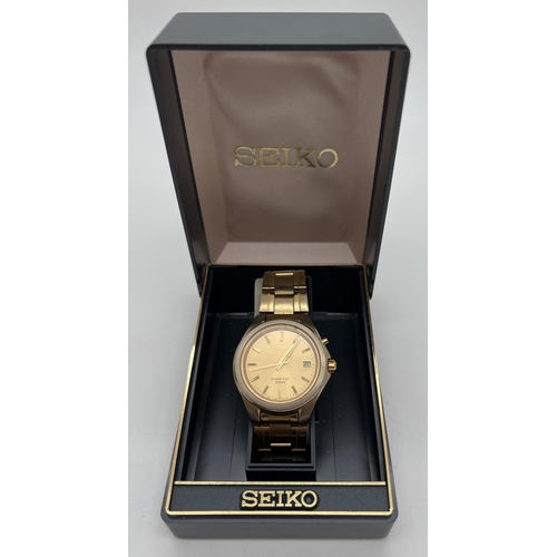 1163 - A boxed Seiko 5M62-OD50 A4 Kinetic gold tone wristwatch with original paperwork. Gold tone face and ... 