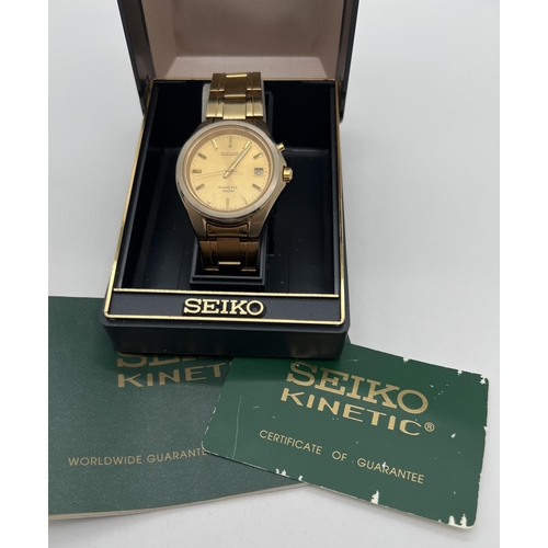 1163 - A boxed Seiko 5M62-OD50 A4 Kinetic gold tone wristwatch with original paperwork. Gold tone face and ... 