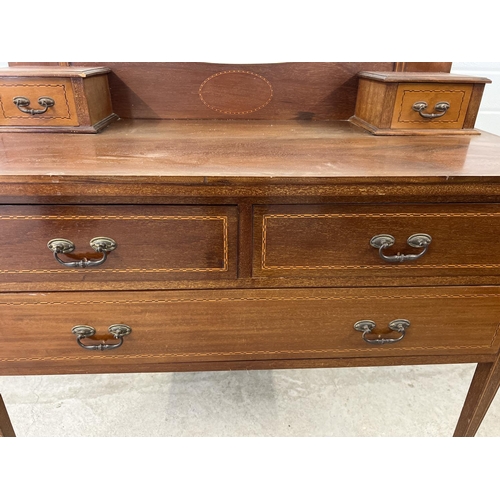 1433 - An Edwardian satin wood dressing table with inlaid detial and tapered legs raised on ceramic caster ... 