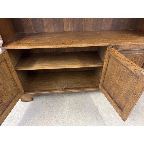 1435 - A vintage Simon Simpson, Norwich, solid dark oak bookcase with 3 door cupboard underside. Double and... 