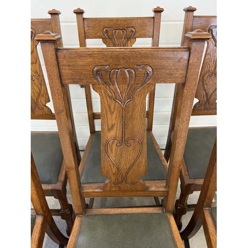 1438 - A set of 6 Art Nouveau dark oak dining chairs with turned legs and stylised carved backs. Turned fro... 