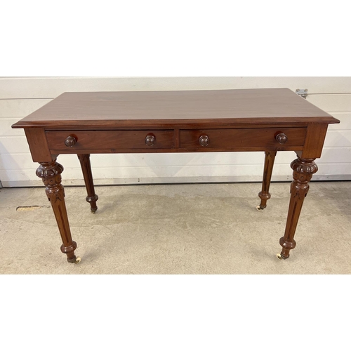 1440 - A Victorian dark wood 2 drawer hall/console table with decorative carved legs and raised on ceramic ... 