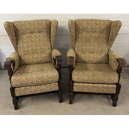 1441 - A pair of vintage 1930's dark oak framed wing back chairs with floral design upholstery and turned f... 