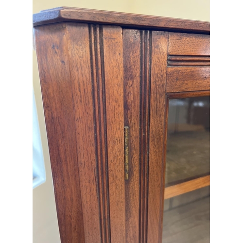 1443 - An Art Deco dark oak 2 door, glass fronted bookcase with channelled detail, complete with key. 4 sol... 