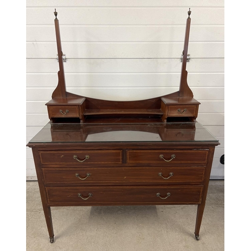 1444 - An Edwardian satin wood dressing table with inlaid detail, tapered legs and brass caster feet. Curve... 