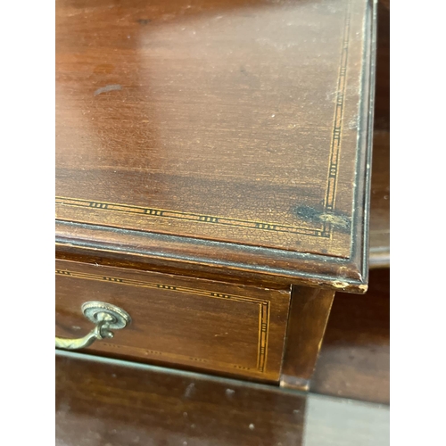 1444 - An Edwardian satin wood dressing table with inlaid detail, tapered legs and brass caster feet. Curve... 