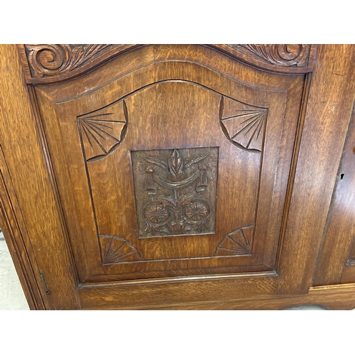 1445 - An Edwardian dark oak mirror backed side board with decorative carved columns and panelled detail. B... 