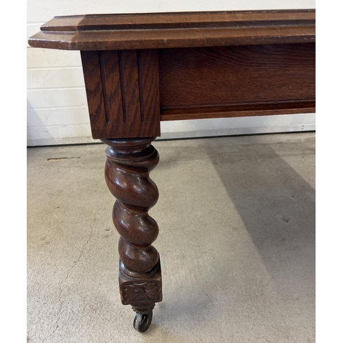 1447 - An antique dark oak wind out, extending dining table with barley twist legs raised on square shaped ... 