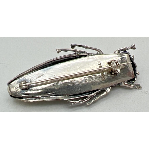 1066 - A sterling silver brooch modelled as a locust, stamped sterling to reverse. Approx. 4.75cm long.