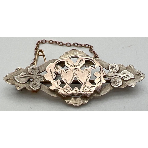 1405 - An antique silver and gold sweetheart brooch with pierced work detail and floral & love heart decora... 