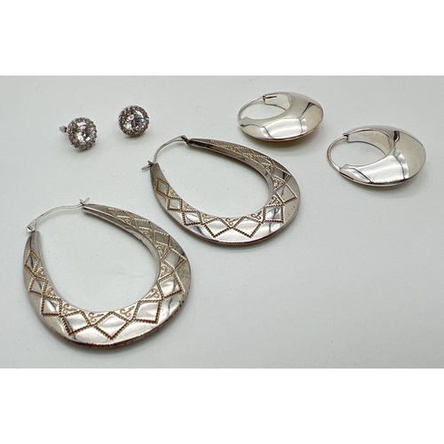 1408 - 3 pairs of silver earrings. A stud style pair set with clear round cut stones, a pair of modern bubb... 