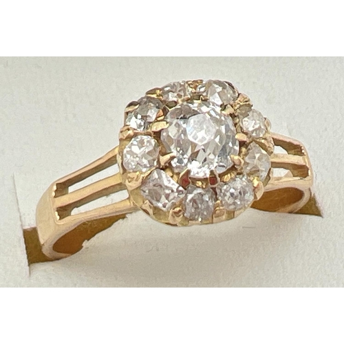 1083 - A vintage yellow gold 1ct diamond halo set cluster ring. Central round cut stone surrounded by 9 var... 