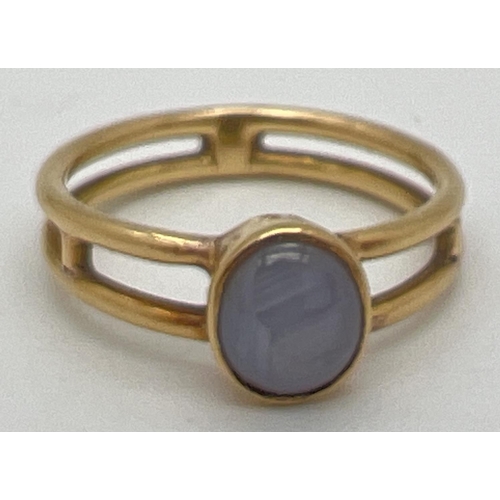 1088 - A bespoke made Macintosh style double band yellow metal dress ring with a bezel set oval grey agate ... 