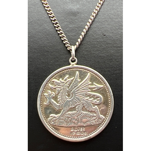1010 - A vintage silver circular pendant with Welsh Dragon to one side and Prince Of Wales feathers to reve... 