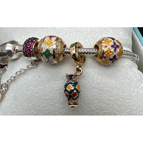 1021 - A boxed silver Ownory charm bracelet with enameled and stone set charms from the Benjarong collectio... 