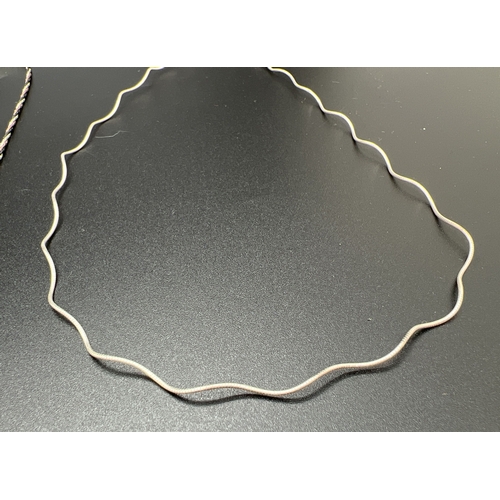 1039 - 2 decorative silver chain necklaces. A tri coloured twist design chain with lobster style clasp. Tog... 