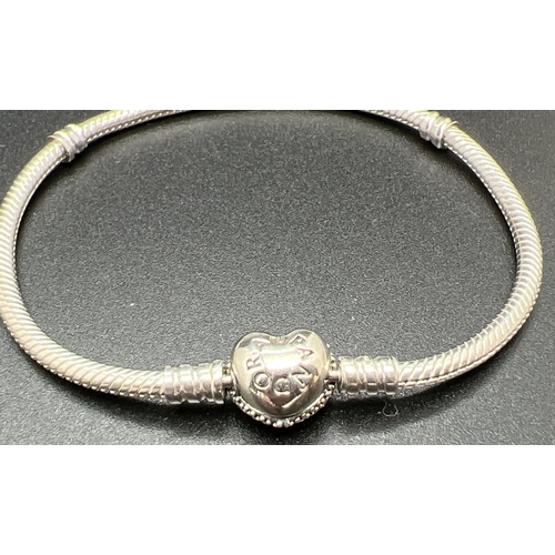 1044 - A boxed Pandora Moments Sparkling Heart Pave Clasp charm bracelet. Clasp set with multiple small cle... 